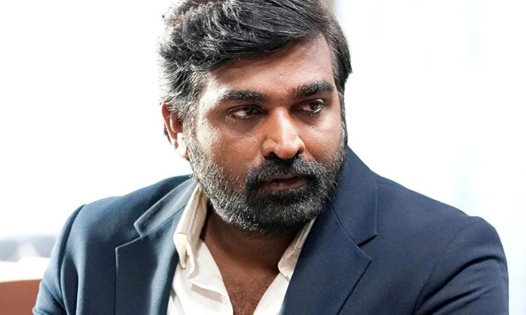 Vijay Sethupathi smiling at a film promotion event in Chennai