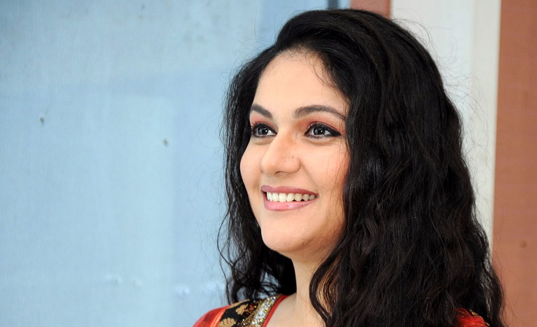 Gracy Singh smiling at a public event, reflecting on her Bollywood career and spiritual journey