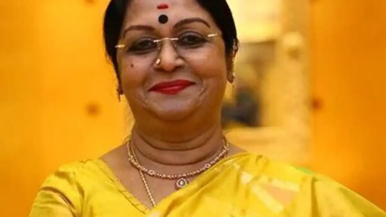 B. Saroja Devi smiling in a traditional saree during a public event – South Indian cinema legend