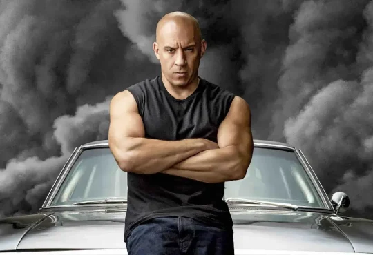 Vin Diesel posing with his luxury cars from Fast and Furious showcasing his net worth and car collection