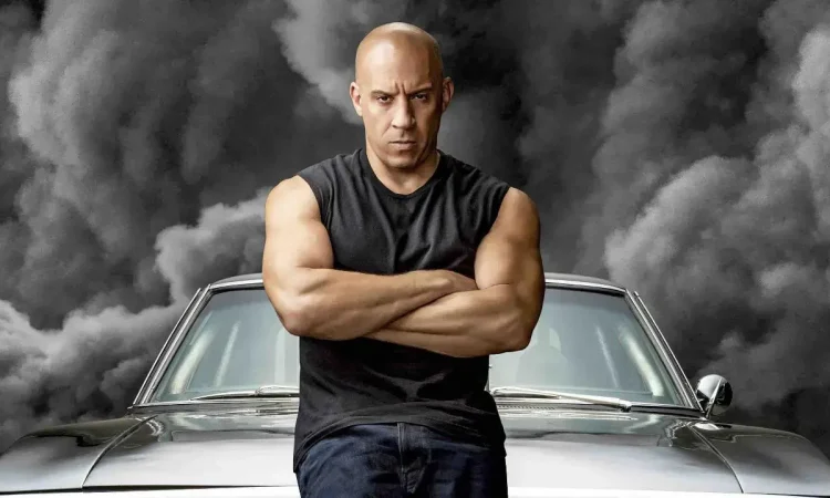 Vin Diesel posing with his luxury cars from Fast and Furious showcasing his net worth and car collection