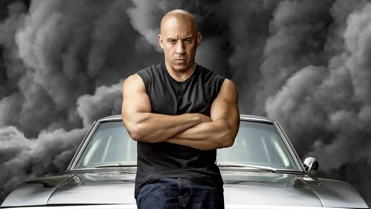 Vin Diesel posing with his luxury cars from Fast and Furious showcasing his net worth and car collection