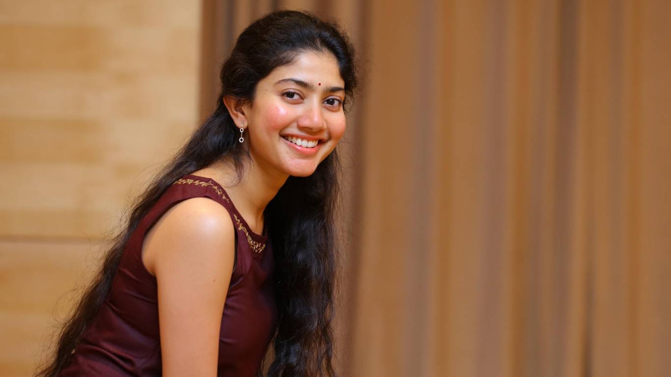 Sai Pallavi smiling with glowing skin, showcasing her natural beauty without makeup