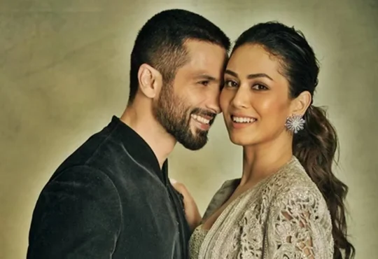 Mira Rajput smiling with Shahid Kapoor at a public event, showcasing her elegance and charm