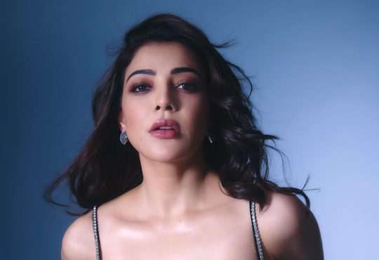 Kajal Agarwal in 2025 smiling at a film event wearing an elegant designer outfit