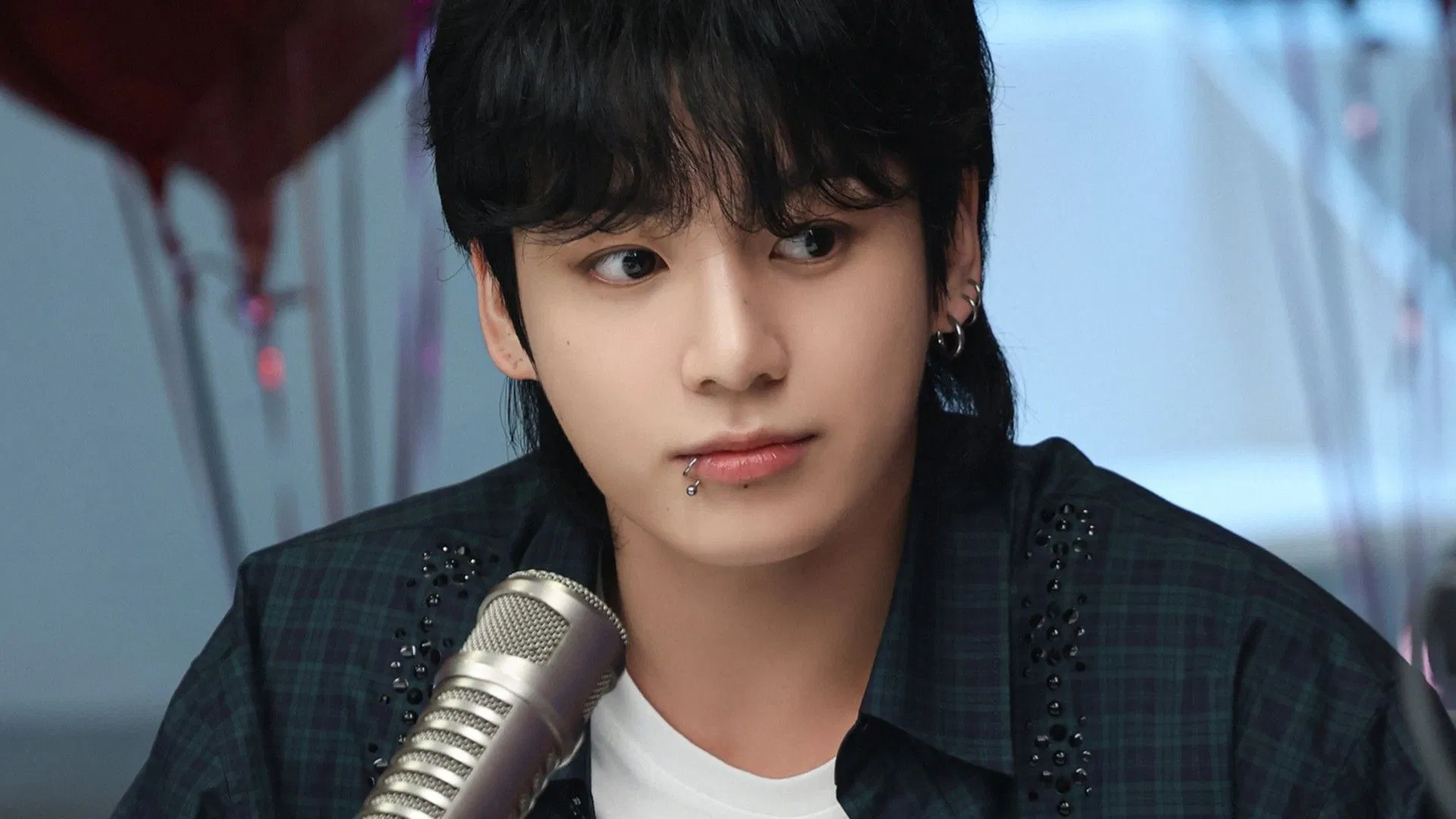 Jungkook at the airport in monochrome outfit, sparking fan speculation