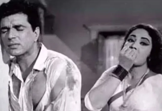 Dharmendra and Meena Kumari together on a classic Bollywood film set