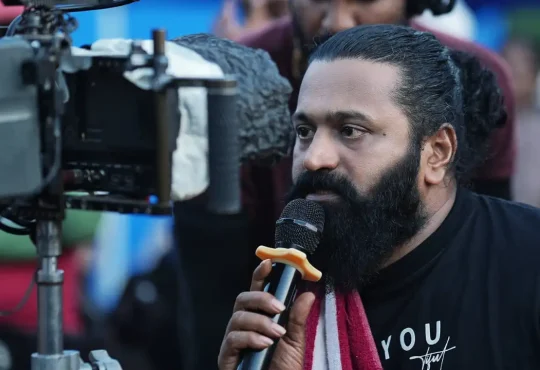 Behind the scenes in Bollywood film set showing actors, crew, and filmmakers working